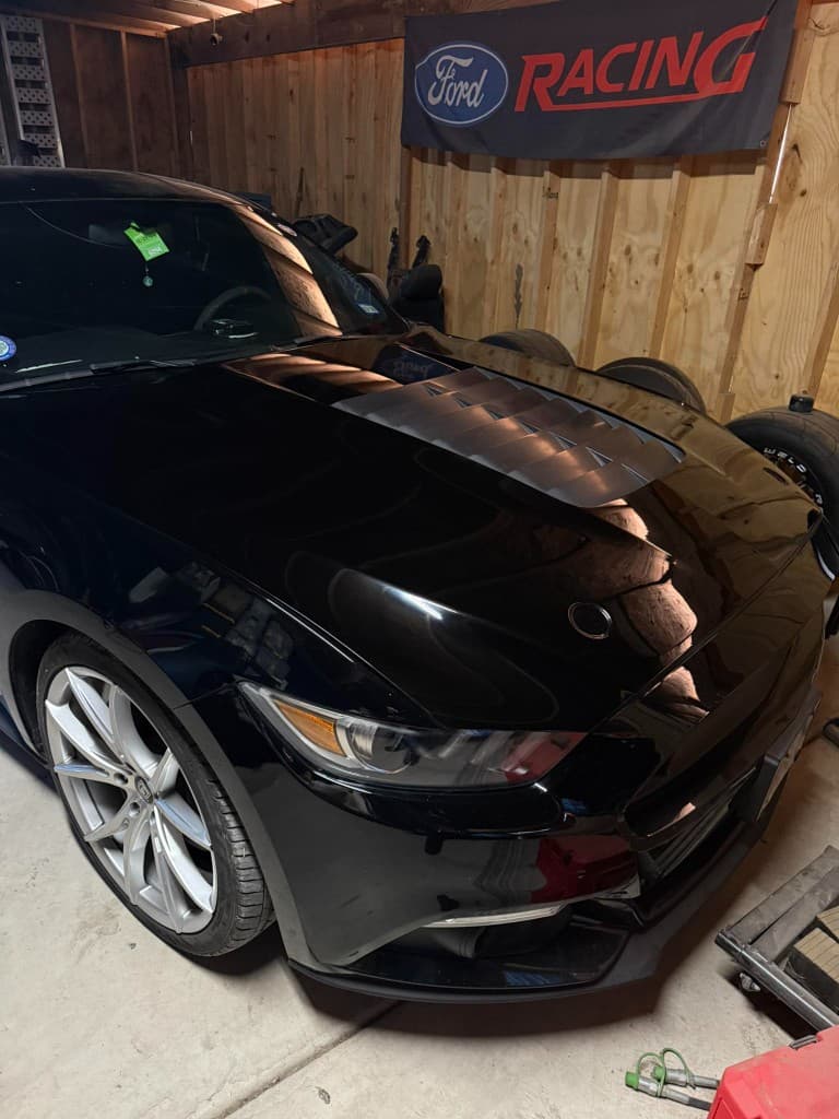 Black Ford Mustang GT under a Ford Racing banner